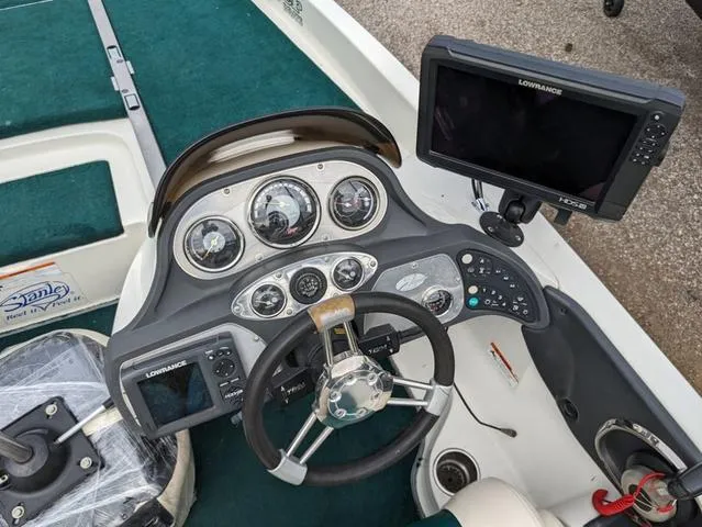 Slide: The Image of 2008 Ranger Comanche Z19 boat dashboard with Lowrance electronics and steering wheel. - 12