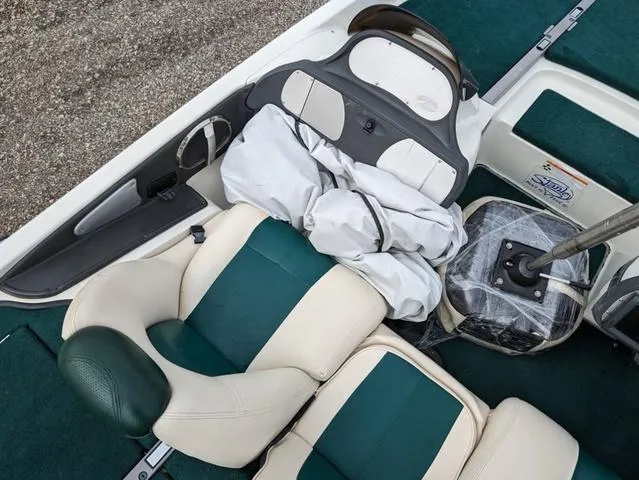 Slide: The Image of 2008 Ranger Comanche Z19 boat interior with green and white seats. - 13