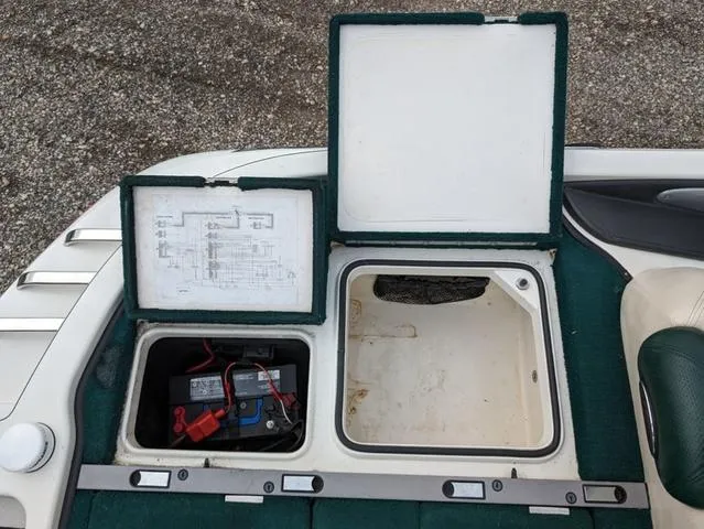 Slide: The Image of Open storage compartments on a 2008 Ranger Comanche Z19 boat, showing battery and wiring. - 14
