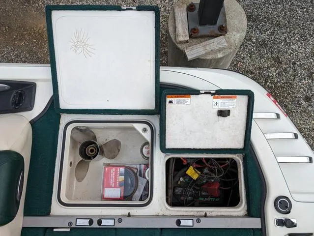 Slide: The Image of Open compartments of a 2008 Ranger Comanche Z19 boat showing propeller and battery. - 16