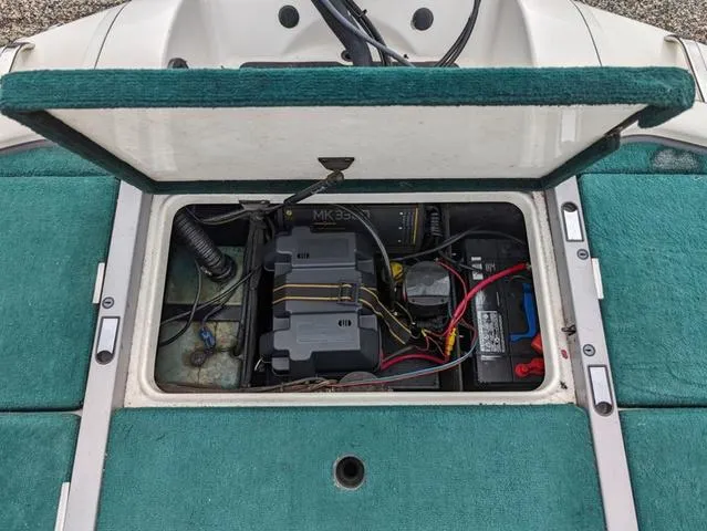 Slide: The Image of 2008 Ranger Comanche Z19 boat battery compartment with wiring and components. - 17