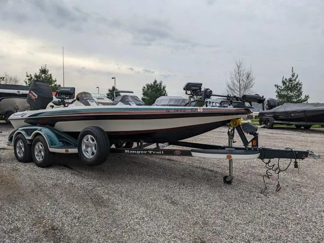 Slide: The Image of 2008 Ranger Comanche Z19 bass boat on a trailer in a parking lot. - 2