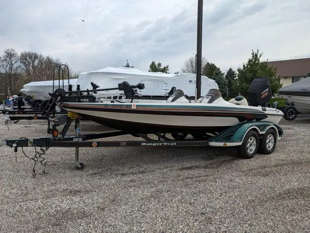 Slide: The Image of 2008 Ranger Comanche Z19 fishing boat on a trailer in a parking lot. - 20