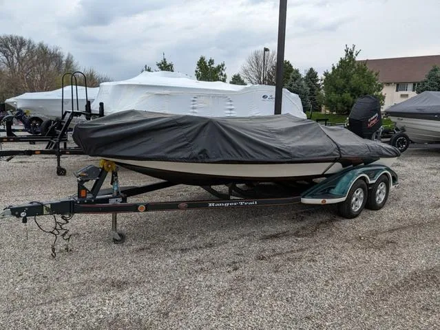 Slide: The Image of 2008 Ranger Comanche Z19 boat on a trailer, covered with a black tarp. - 21