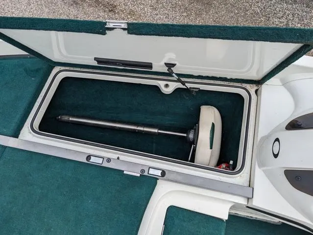 Slide: The Image of Storage compartment of a 2008 Ranger Comanche Z19 boat with green carpet. - 8