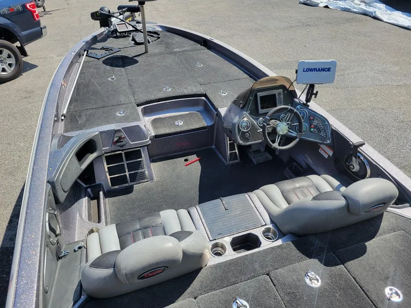 Slide: The Image of Interior of a 2011 Ranger Z521 boat with steering console and Lowrance electronics. - 13