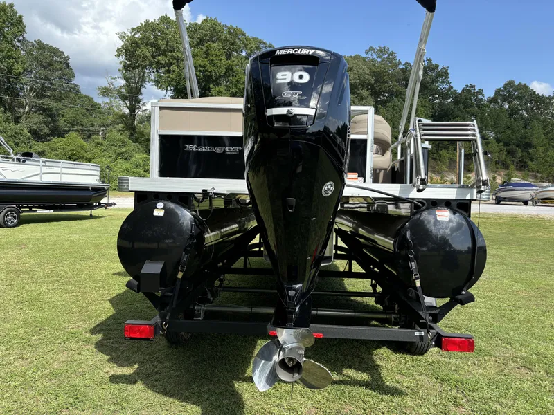 Slide: The Image of 2024 Ranger 200C pontoon boat with Mercury 90 engine on grassy area. - 10