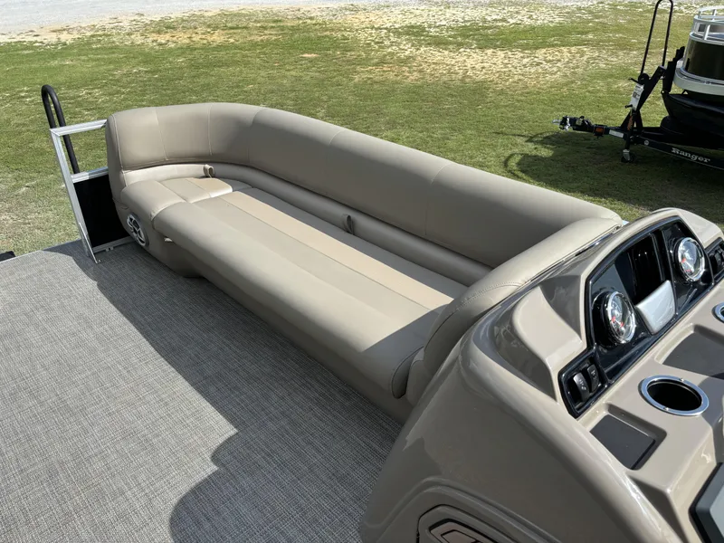 Slide: The Image of 2024 Ranger 200C boat interior with beige seating and modern dashboard. - 14