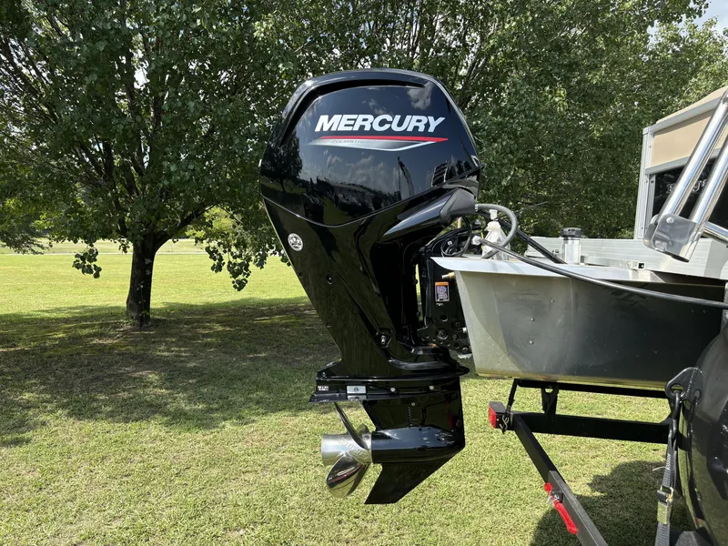 Slide: The Image of 2024 Ranger 200C boat with Mercury outboard motor in a grassy area. - 5