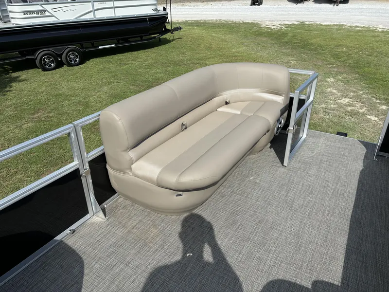 Slide: The Image of 2024 Ranger 200C pontoon boat with beige seating on a sunny day. - 8