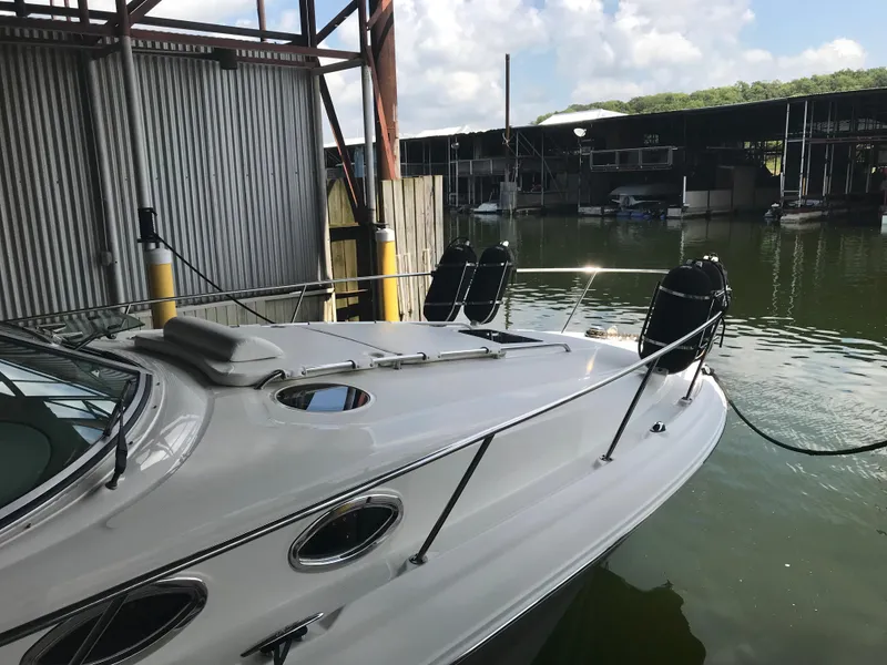 Slide: The Image of 2007 Sea Ray 320 Sundancer docked in a marina under a clear sky. - 10