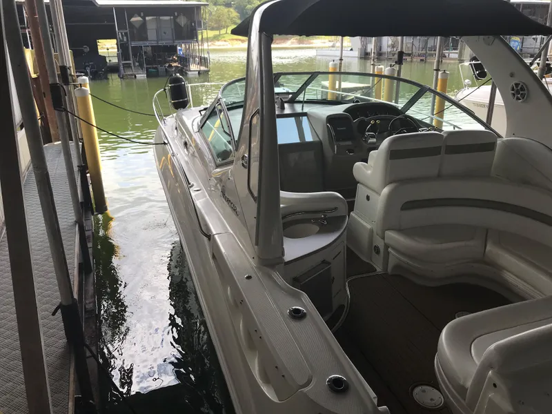 Slide: The Image of 2007 Sea Ray 320 Sundancer docked, showcasing sleek design and spacious interior. - 14