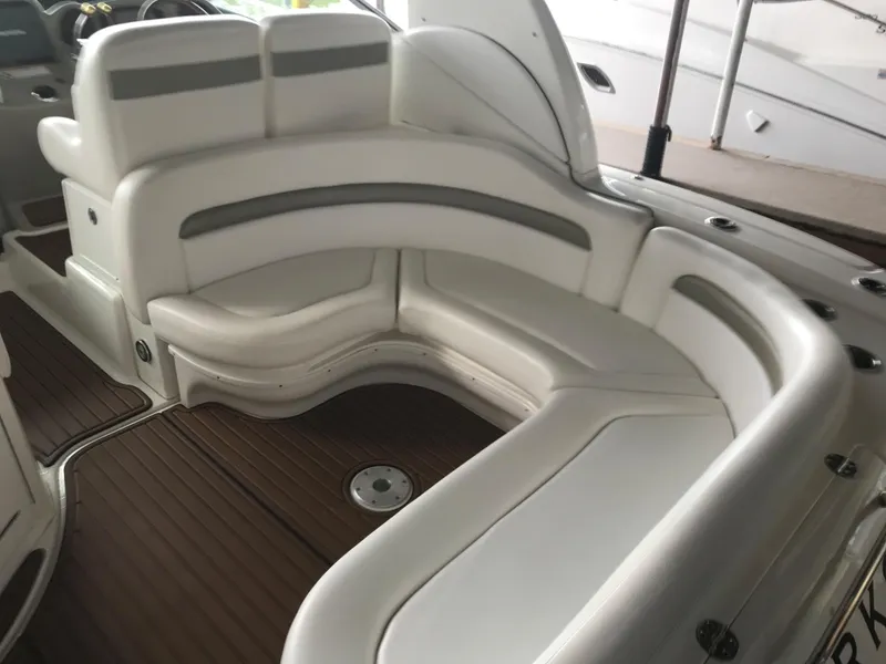 Slide: The Image of 2007 Sea Ray 320 Sundancer interior with white leather seating and wood flooring. - 15