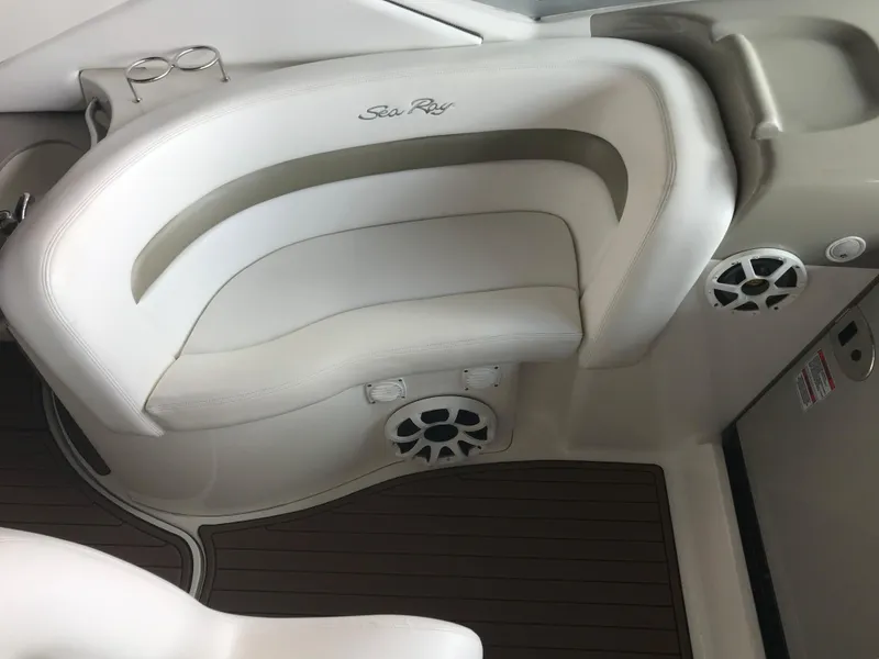 Slide: The Image of 2007 Sea Ray 320 Sundancer interior with white seating and wood-style flooring. - 18