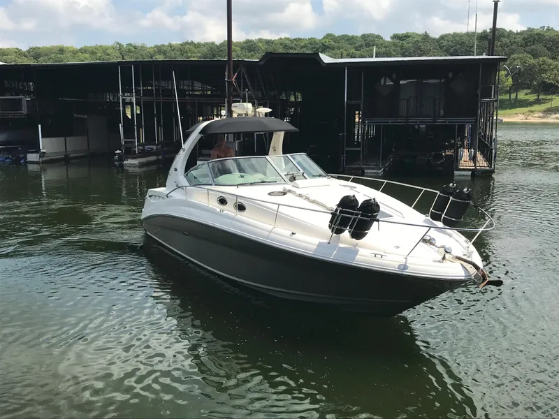 Slide: The Image of 2007 Sea Ray 320 Sundancer boat docked on a calm lake. - 4