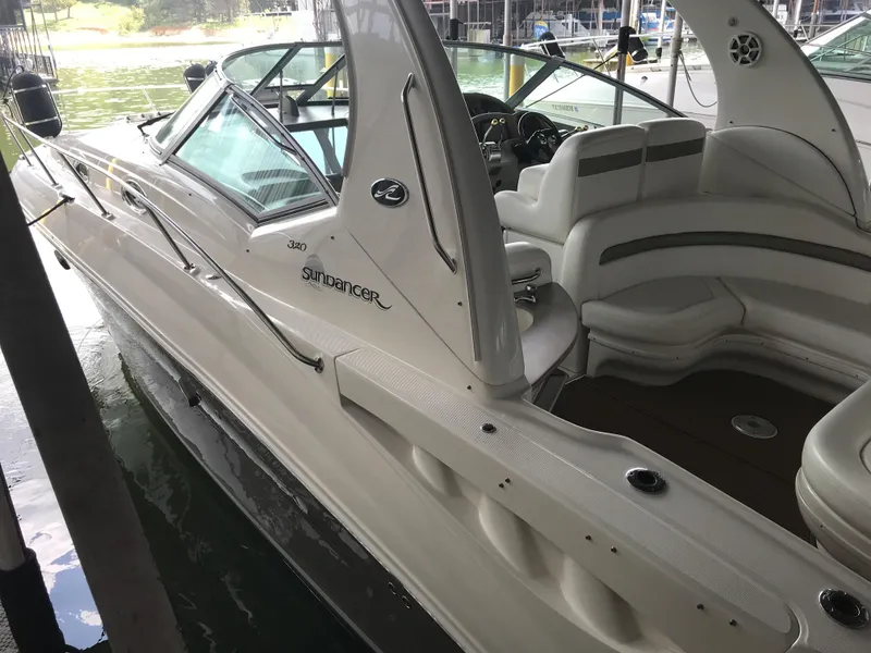 Slide: The Image of 2007 Sea Ray 320 Sundancer boat docked, featuring sleek design and spacious seating. - 7