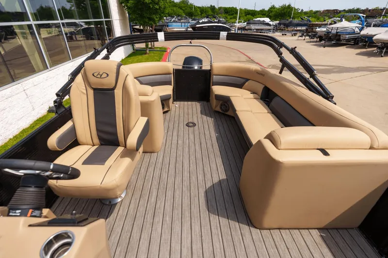 Slide: The Image of 2022 Harris 230 CRUISER boat interior with beige seating and modern design. - 14