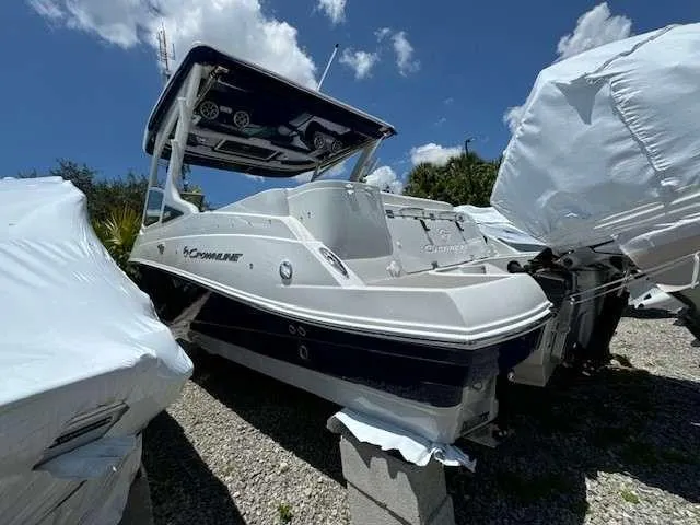 Slide: The Image of 2024 Crownline 280 DC boat displayed outdoors under a clear blue sky. - 4