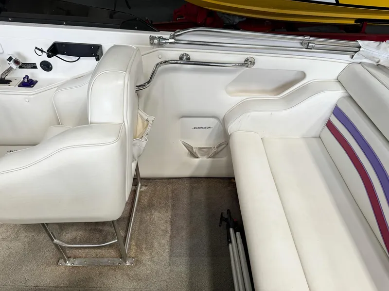 Slide: The Image of Interior of a 1998 Eliminator 280 Eagle XP boat with white seating and carpet. - 14