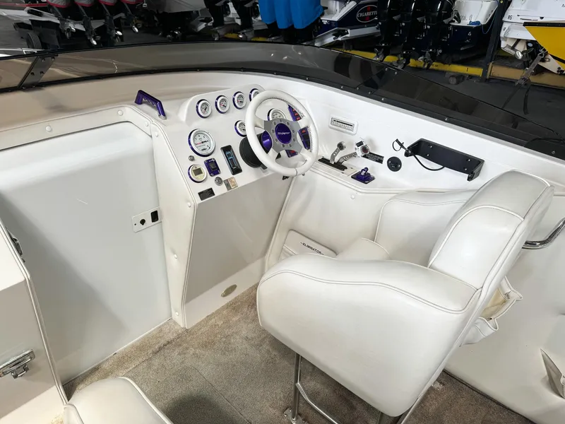 Slide: The Image of 1998 Eliminator 280 Eagle XP boat cockpit with white and purple controls. - 15
