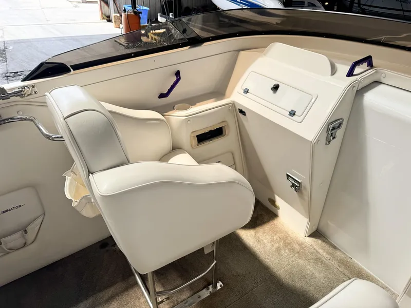 Slide: The Image of Interior of a 1998 Eliminator 280 Eagle XP boat with white seating and storage compartments. - 16