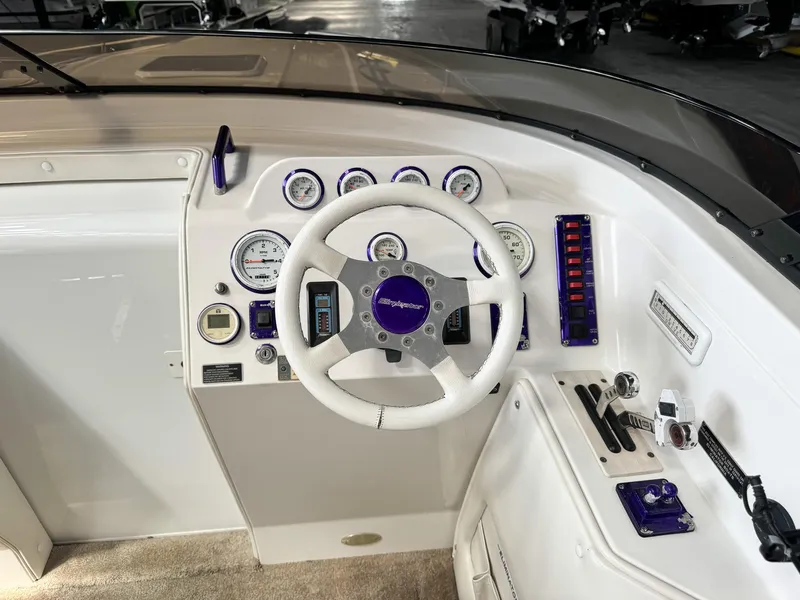 Slide: The Image of 1998 Eliminator 280 Eagle XP boat dashboard with steering wheel and instrument panel. - 17