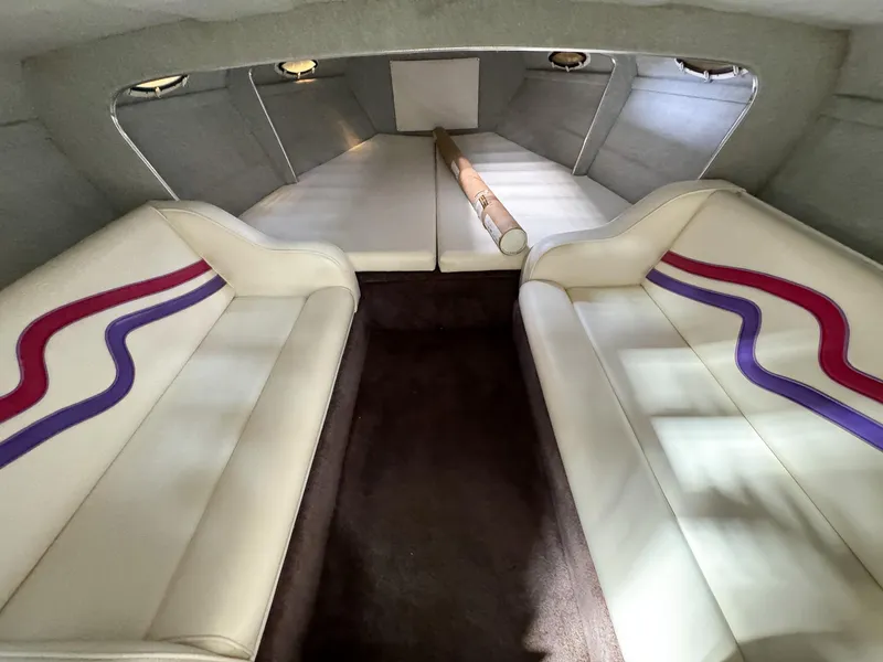 Slide: The Image of Interior of 1998 Eliminator 280 Eagle XP boat with white and purple seating. - 18