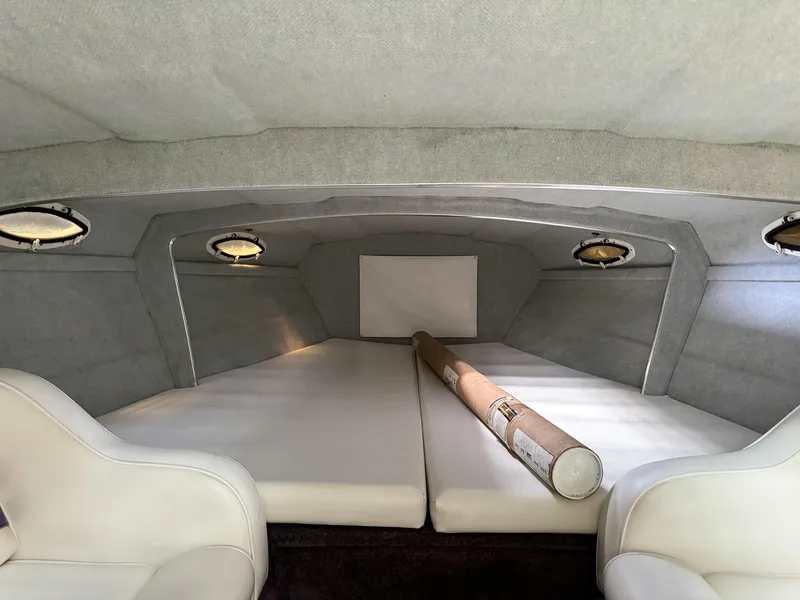 Slide: The Image of 1998 Eliminator 280 Eagle XP boat cabin interior with white seating and cushions. - 24