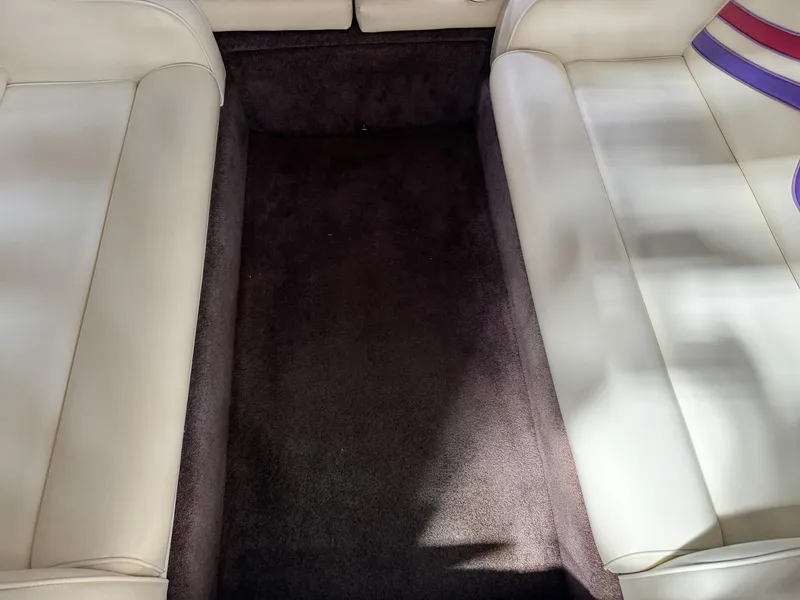 Slide: The Image of Interior seating of a 1998 Eliminator 280 Eagle XP boat with white upholstery. - 26