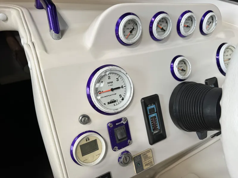 Slide: The Image of Dashboard of a 1998 Eliminator 280 Eagle XP boat with gauges and controls. - 27