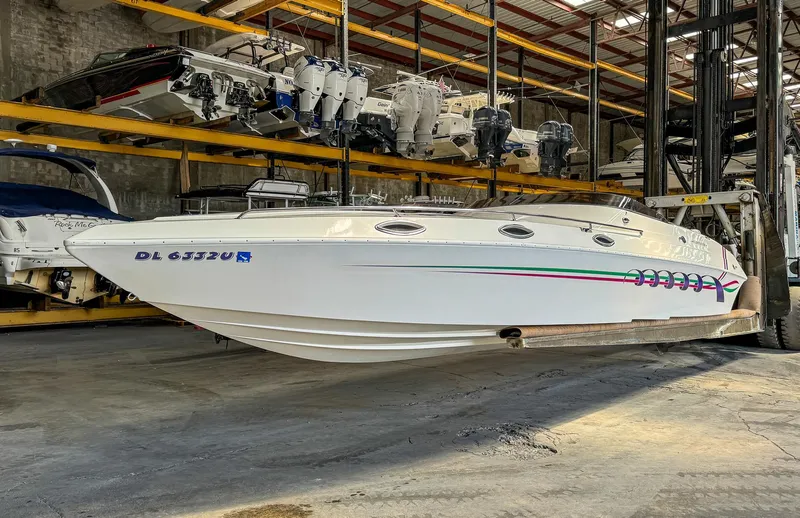 Slide: The Image of 1998 Eliminator 280 Eagle XP speedboat in indoor storage facility. - 3