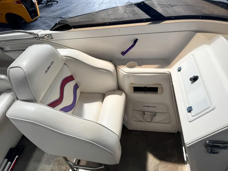Slide: The Image of 1998 Eliminator 280 Eagle XP boat interior with white and purple seating. - 30