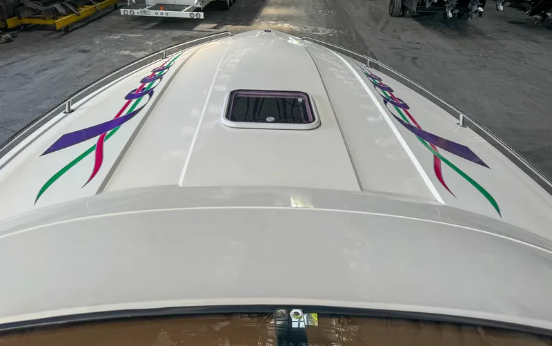 Slide: The Image of 1998 Eliminator 280 Eagle XP boat with colorful graphics on deck. - 31
