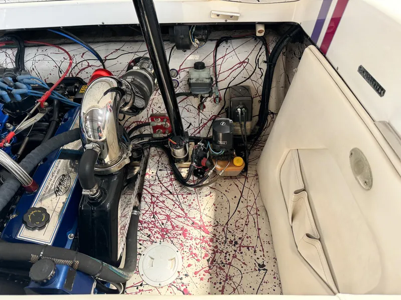 Slide: The Image of 1998 Eliminator 280 Eagle XP boat engine compartment with colorful splatter paint design. - 35
