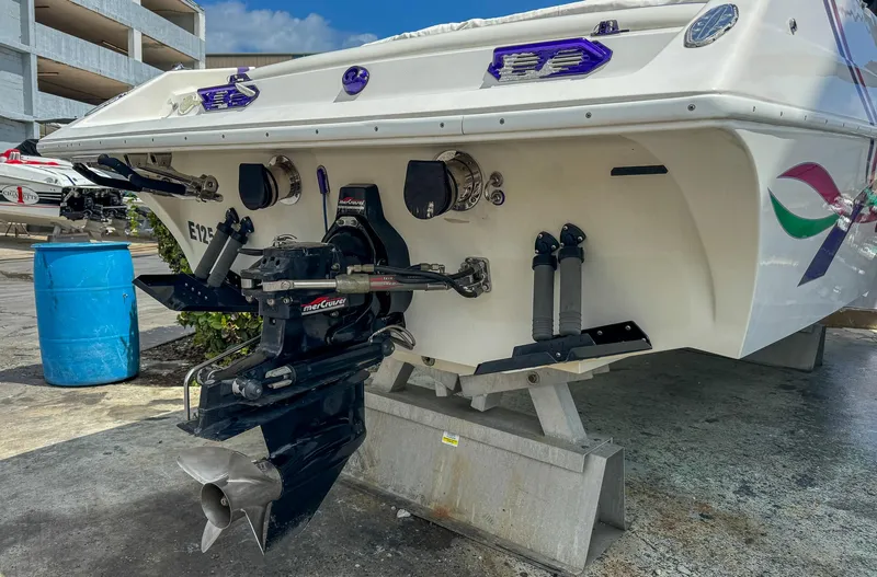 Slide: The Image of 1998 Eliminator 280 Eagle XP boat stern with outboard motor on stand. - 41