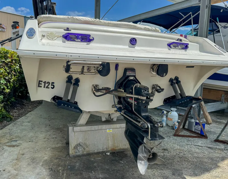 Slide: The Image of 1998 Eliminator 280 Eagle XP boat on dry dock, rear view showing outdrive and propeller. - 42