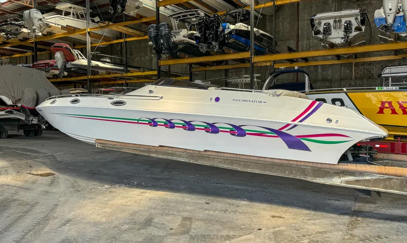 Slide: The Image of 1998 Eliminator 280 Eagle XP speedboat in storage facility. - 5