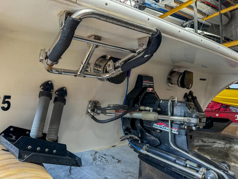 Slide: The Image of 1998 Eliminator 280 Eagle XP boat stern with MerCruiser outdrive in a garage. - 7