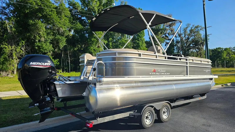 Slide: The Image of 2024 Sun Tracker Party Barge 24 DLX pontoon boat with Mercury outboard motor. - 2