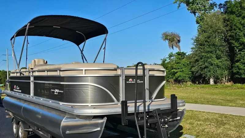 Slide: The Image of 2024 Sun Tracker Party Barge 24 DLX pontoon boat on a trailer, ready for adventure. - 3