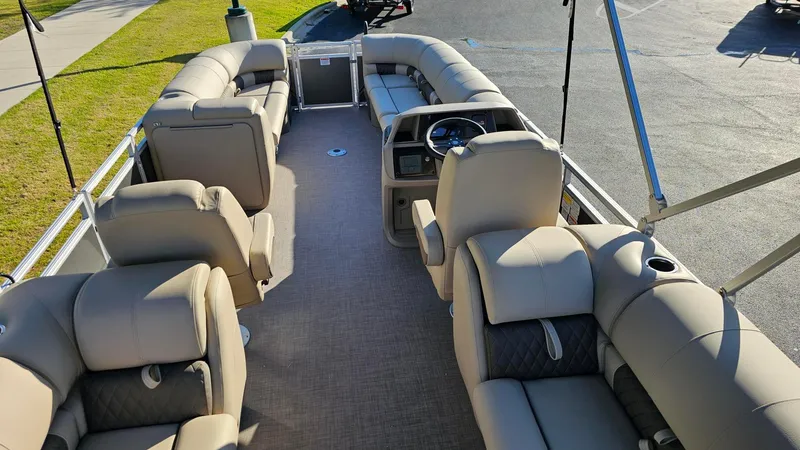 Slide: The Image of 2024 Sun Tracker Party Barge 24 DLX interior with spacious seating and steering console. - 31