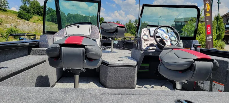 Slide: The Image of 2024 Ranger VS1782SC Reata boat interior with seating and control panel, under a clear blue sky. - 3