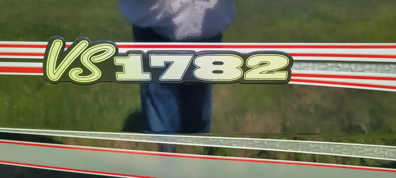 Slide: The Image of 2024 Ranger VS1782SC Reata boat decal with red and silver stripes. - 5