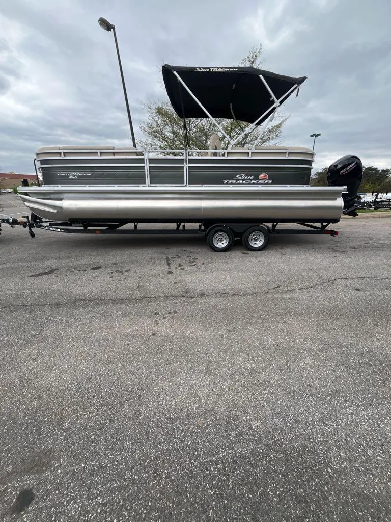 The Image of 2024 Sun Tracker Party Barge 24 DLX pontoon boat on trailer, outdoor display. - 0