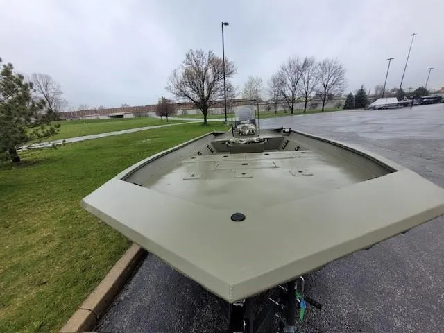 Slide: The Image of 2024 Tracker Grizzly 2072 CC boat in a parking lot on a cloudy day. - 3