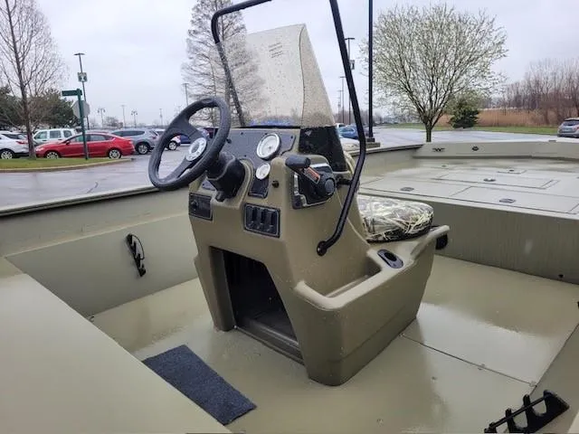 Slide: The Image of 2024 Tracker Grizzly 2072 CC boat interior with steering console and controls. - 4