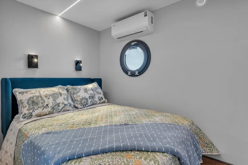 Slide: The Image of Modern bedroom in 2024 Waterlodge Apart EL with porthole window and air conditioning. - 11