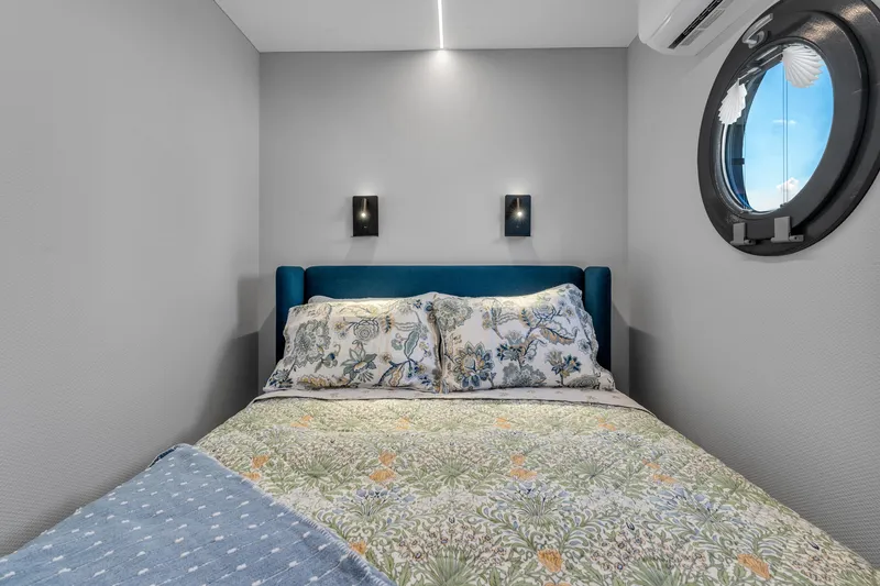 Slide: The Image of Cozy bedroom in 2024 Waterlodge Apart EL with porthole window and modern decor. - 12