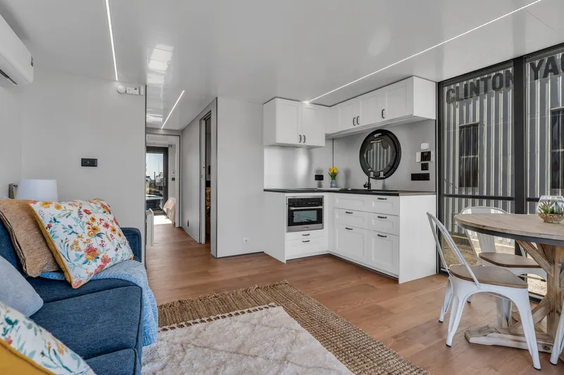 Slide: The Image of Modern Waterlodge Apart EL 2024 interior with kitchen, dining area, and cozy living space. - 18