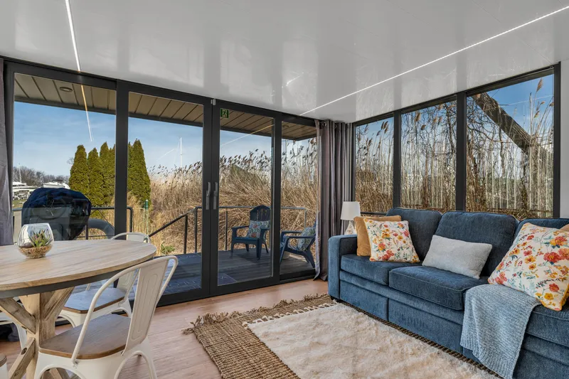 Slide: The Image of Modern Waterlodge Apart EL 2024 interior with cozy living area and scenic outdoor view. - 20